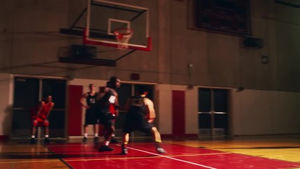 Basketball teammates playing one one one, running drills before a game