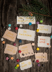 New Year goals or resolutions with decorations on rustic wooden background