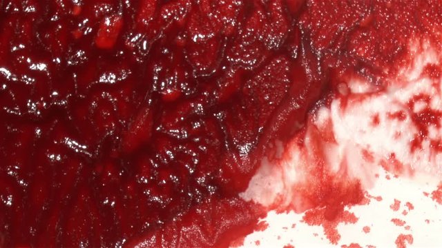 Red blood absorbing into white paper or tissue.