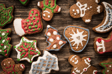 Colorfully Christmas cookies on rustic wooden background