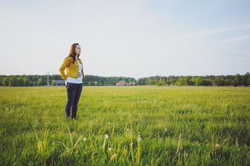 Fototapeta premium Happy young girl enjoying the beauty of sunny spring day