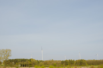 Bright blue sky moving and wind turbine