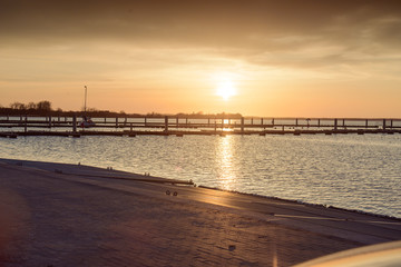 Fototapeta premium Yacht port over orange sunset