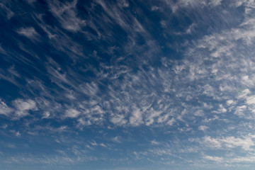 Naklejka na ściany i meble Dramatic sky with small white clouds.
