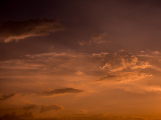 Fototapeta na wymiar Dramatic sunset sky with orange colored clouds.
