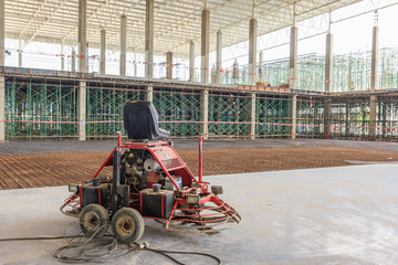 Double power trowel finishing concrete floor at construction building site , smooth concrete surface.