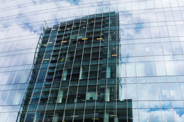 Fototapeta na wymiar office building reflecting in a glass facade