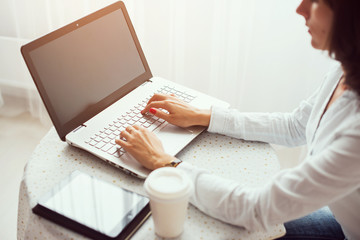 Woman working in home office hand on keyboard close up.