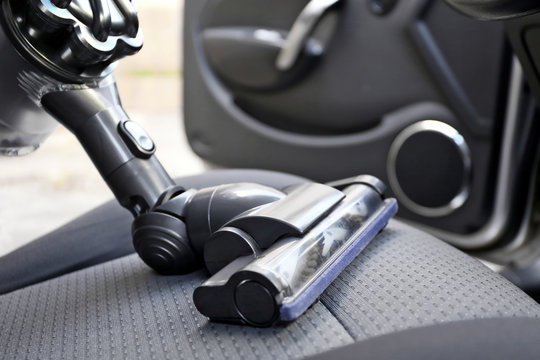 Cleaning the car seat with vacuum cleaner