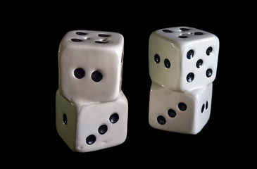 Porcelain dices isolated in black.