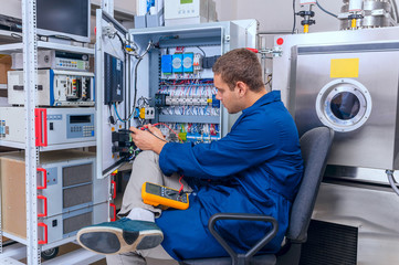Engineer working with digital multimeter in the lab