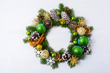 Fototapeta na wymiar Christmas wreath dried oranges, pine cones and cinnamon sticks