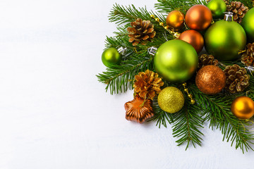 Fototapeta na wymiar Green Christmas ornaments, fir branches, golden pine cones and b