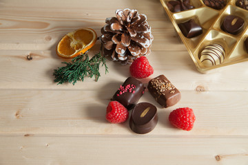 lot of variety chocolate pralines on wood background
