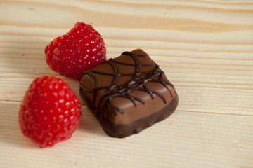 lot of variety chocolate pralines on wood background