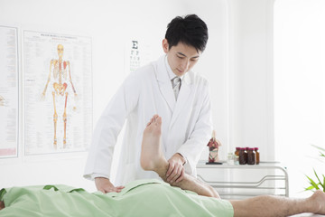 Men are undergoing leg examinations