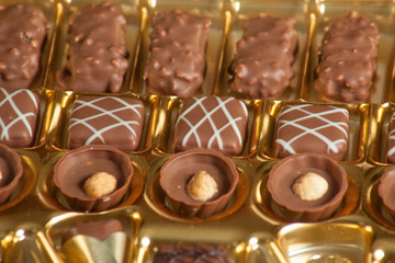 lot of variety chocolate pralines on wood background