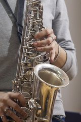 Fototapeta premium Hands girl playing the saxophone 
