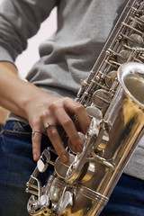 Hands girl playing the saxophone 