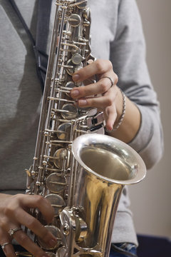 Hands girl playing the saxophone 