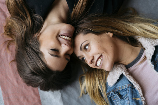 Smiling laying women couple