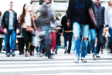 crowds of people crossing a city street