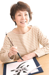 書道をするシニア女性