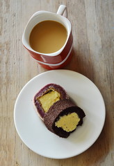 chocolate and grape cake roll stuffed cream eat couple with coffee in red cup