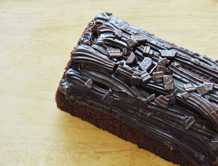 dark chocolate cake jam stuffed cream on wooden chopping block