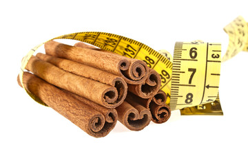 Cinnamon sticks wrapped roulette on a white background