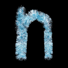 Festive alphabet made of blue tinsel. Letter N on black background. Isolated