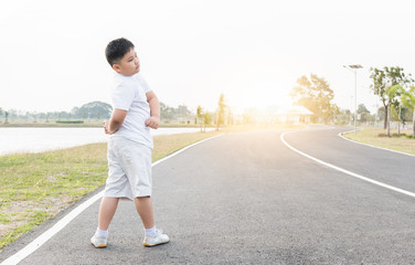 Obese fat boy exercise at park on morning