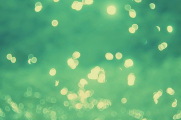 Blur tropical sunset beach with bokeh sun light wave abstract background.