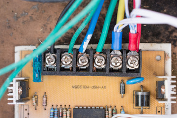 Colored wires and screws. Electric device inside
