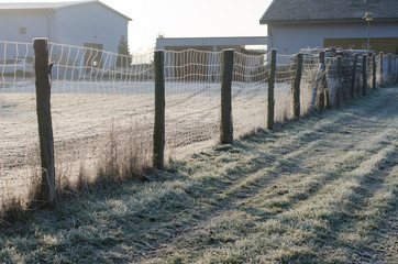 wooden fence on a cold winter morning in the countryside