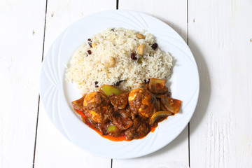 Egg curry served with roti/chapati/pulao/pilaf rice.