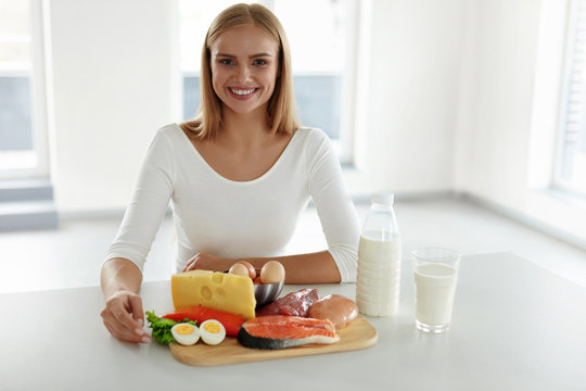 Healthy Nutrition. Beautiful Woman With Product In Kitchen. Food