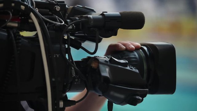 hand on the focus of the camera lens
