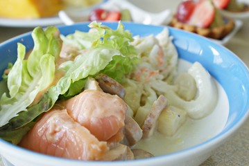 Smoked salmon salad mixed with vegetables.