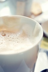 Coffee cup with milky white foam.