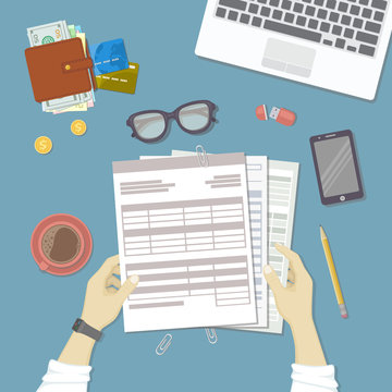 Man working with documents. Human hands hold the accounts, bills, tax form. Workplace with papers, blanks, forms, phone, wallet with money, credit cards, glasses, coins, leptop coffee. Top view Vector