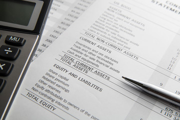 Pen, calculator On the financial account documents. Financial co