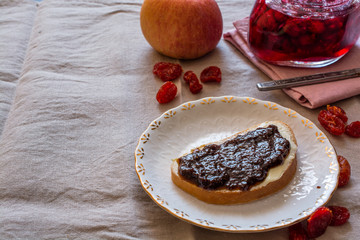 Homemade toast with butter and jam on cloth.