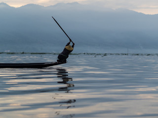 Fototapeta na wymiar Unrecognizable fishermen in sunrise at Lake Inle