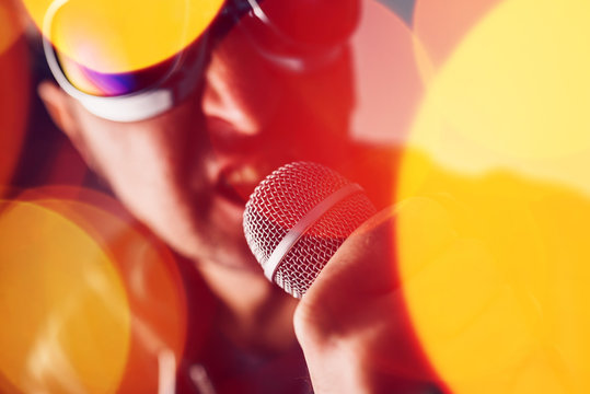 Alternative rock music singer singing song into microphone