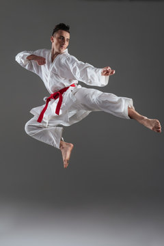 Attractive young sportsman dressed in kimono practice in karate