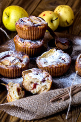 Apple muffins with bowl of honey on wood background