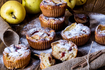 Apple muffins with bowl of honey on wood background