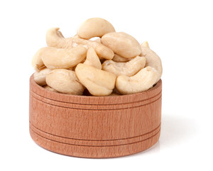 cashew nuts in a wooden bowl isolated on white background