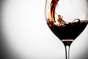 Photo on glass stem on gray background with red wine